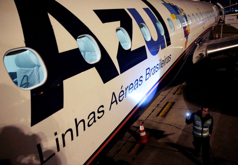 &copy; Reuters. FILE PHOTO: An employee of Azul Brazilian Airlines checks the Embraer 190 plane at International Airport in Guarulhos, Brazil July 11, 2018. REUTERS/Leonardo Benassatto/File Photo