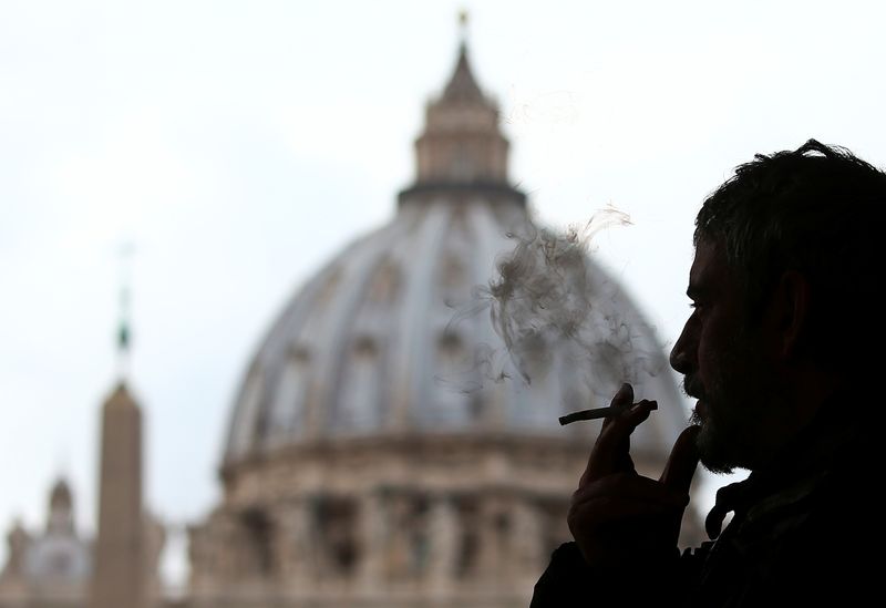 &copy; Reuters. FILE PHOTO: A man smokes a cigarette in front of St. Peter Square, in Rome, Italy November 9, 2017. REUTERS/Alessandro Bianchi