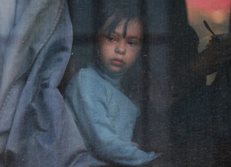 &copy; Reuters. FILE PHOTO: A child looks out of a bus window as civilians evacuated from the Russian-controlled Kherson region of Ukraine arrive at a local railway station, after Russian-installed officials extended an evacuation order to the area along the eastern bank