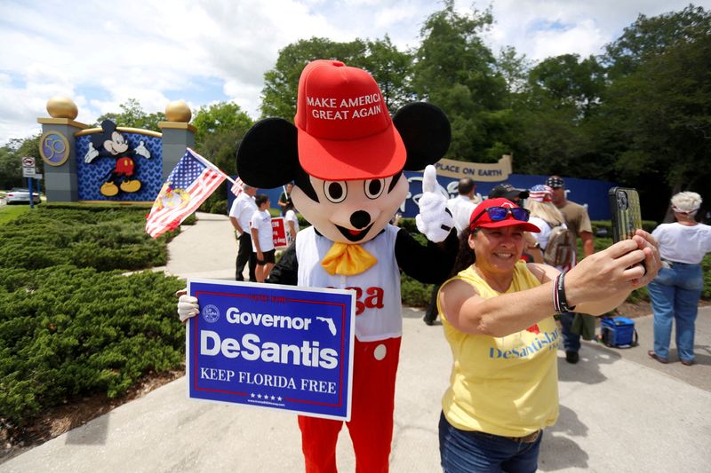 &copy; Reuters. FILE PHOTO: A person wearing a mouse costume takes selfies with supporters of Florida's Republican-backed "Don't Say Gay" bill that bans classroom instruction on sexual orientation and gender identity for many young students gather for a rally outside Wal