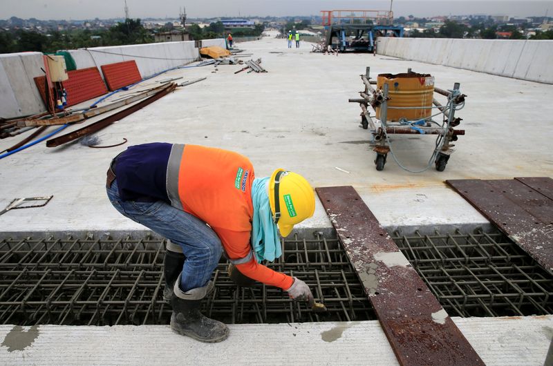 &copy; Reuters. FILE PHOTO: A construction worker stands over the newly dried concrete and secure linking steel bars of the 5.58 kilometre elevated highway in Caloocan City, metro Manila, Philippines on August 2, 2017. Picture taken august 2, 2017.  REUTERS/Romeo Ranoco