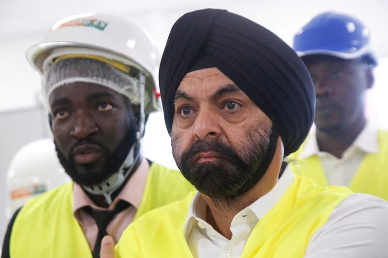 © Reuters. FILE PHOTO: U.S. nominee to head World Bank, Ajay Banga, stands with officials during his visit at the headquarters of Ivorian electricity company of Yopougon in Abidjan, Ivory Coast, March 7, 2023. REUTERS/Luc Gnago/File Photo