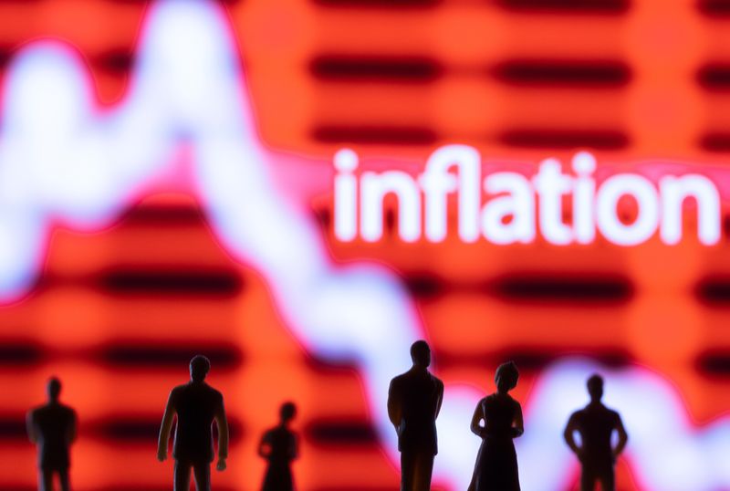 &copy; Reuters. FILE PHOTO: Figurines are seen in front of displayed stock graph and word "Inflation" in this illustration taken June 13, 2022. REUTERS/Dado Ruvic/Illustration