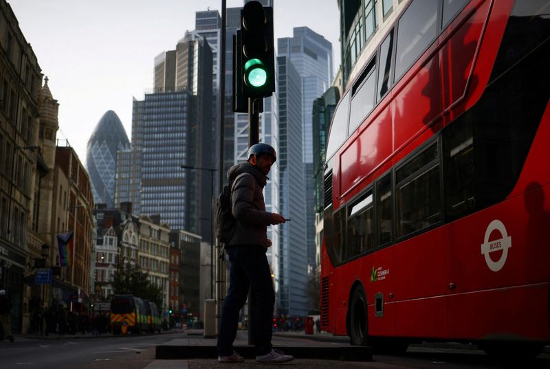 &copy; Reuters. FILE PHOTO: A person walks through the City of London financial district in London, Britain, February 10, 2023. REUTERS/Henry Nicholls/File Photo