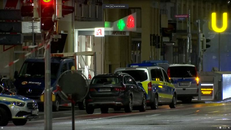 © Reuters. German police vehicles are seen at the scene of a hostage situation inside a pharmacy in Karlsruhe, Germany March 10, 2023 in this screen grab from video. Reuters TV/via REUTERS