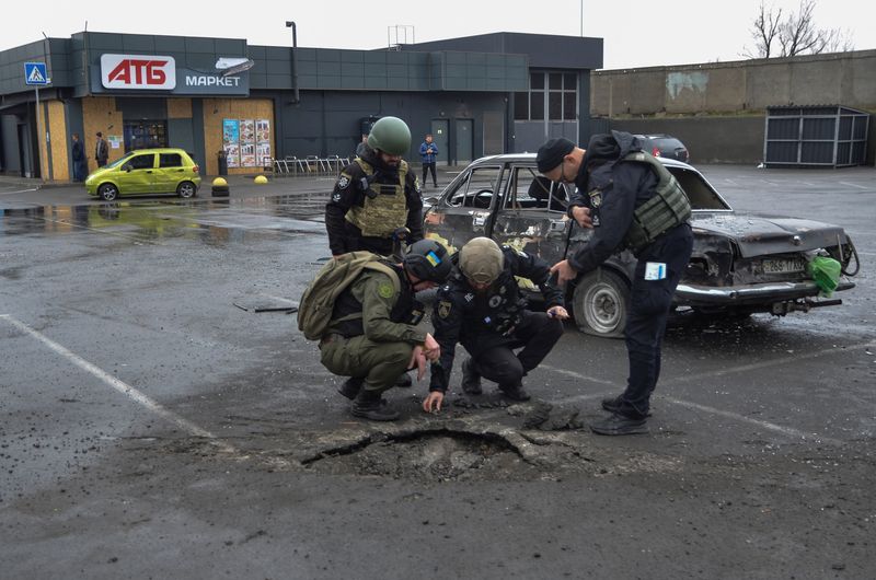 &copy; Reuters. Investigadores da polícia inspecionam uma cratera deixada por um ataque militar russo em estacionamento de supermercado, em meio à ofensiva da Rússia na Ucrânia, em Kherson, Ucrânia
11/03/2023
REUTERS/Ivan Antypenko