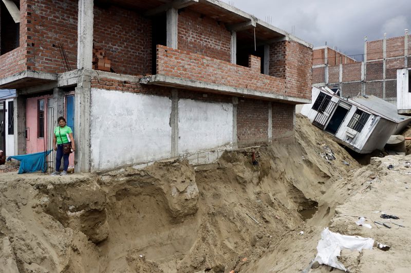 &copy; Reuters. A resident stands near damaged houses in the aftermath of the Moche river overflowing due to torrential rains caused by Cyclone Yaku, in Trujillo, Peru, March 13, 2023. REUTERS/Randy Reyes