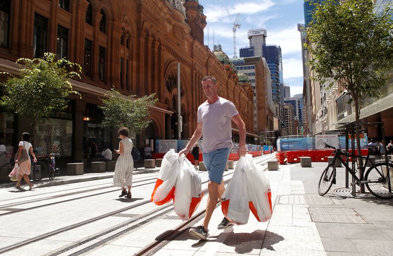 &copy; Reuters. FILE PHOTO: A man carries several shopping bags as he walks along George Street in Sydney's central business district (CBD) Australia, February 5, 2018. Picture taken February 5, 2018. REUTERS/Daniel Munoz/File Photo