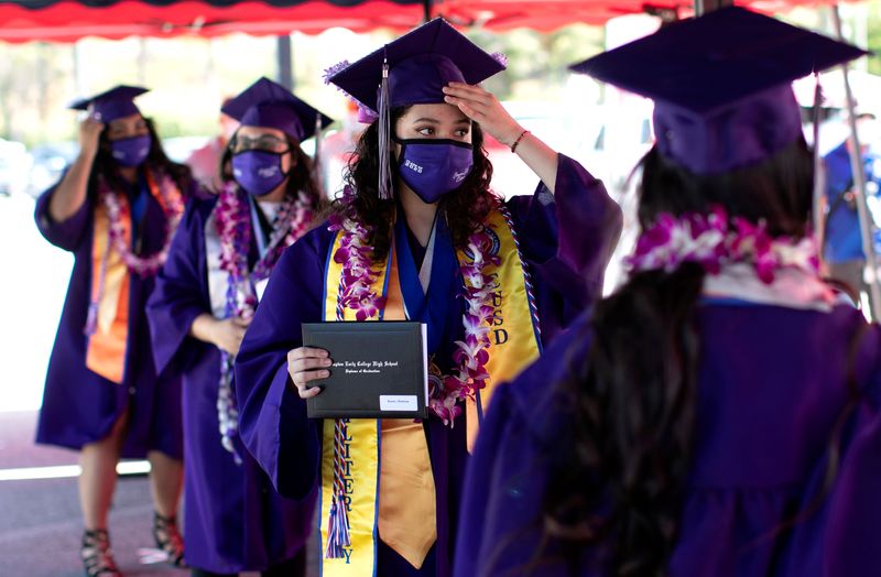 &copy; Reuters. FILE PHOTO: Compton Early College High School graduating student Chelsea Donis adjust her mortar after picking up her diploma in a parking lot during a drive-thru graduating ceremony, during the outbreak of the coronavirus disease (COVID-19) in Compton, C