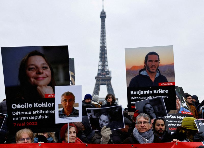 &copy; Reuters. FILE PHOTO: Supporters and relatives of French citizens detained in Iran, Cecile Kohler, Benjamin Briere, Jacques Paris and Fariba Adelkhah, gather in front of the Eiffel Tower, during a rally demanding their release, in Paris, France, January 28, 2023.  