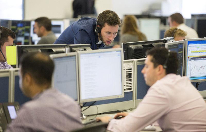 &copy; Reuters. FILE PHOTO: Dealers work on the IG Group trading floor in London, Britain June 30, 2015. REUTERS/Neil Hall