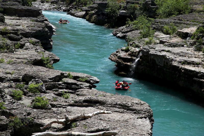 &copy; Reuters. FILE PHOTO: People raft along the Vjosa river, which environmentalists call 'the last wild river in Europe', in Permet, Albania May 23, 2021. REUTERS/Florion Goga/