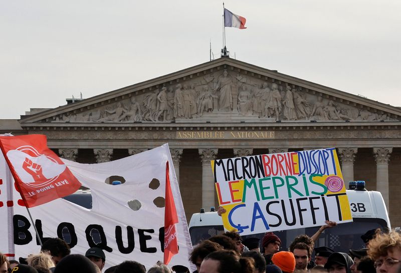 © Reuters. Demonstrators gather in front of the National Assembly to protest after French Prime Minister Elisabeth Borne delivered a speech to announce the use of the article 49.3, a special clause in the French Constitution, to push the pensions reform bill through the lower house of parliament without a vote by lawmakers, in Paris, France, March 16, 2023. The slogan reads 