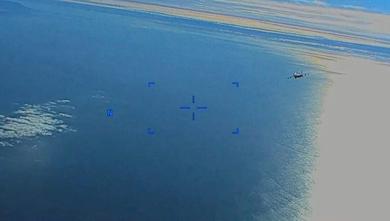 &copy; Reuters. A Russian Su-27 military aircraft flies near a U.S. Air Force MQ-9 "Reaper" drone over the Black Sea, March 14, 2023 in this still image taken from handout video released by the Pentagon. Courtesy of U.S. European Command/The Pentagon/Handout via REUTERS 