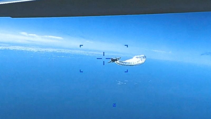 © Reuters. A Russian Su-27 aircraft dumps fuel while flying upon a  U.S. Air Force intelligence, surveillance, and reconnaissance unmanned MQ-9 aircraft over the Black Sea, March 14, 2023 in this still image taken from a handout video. Courtesy of U.S. European Command/Handout via REUTERS