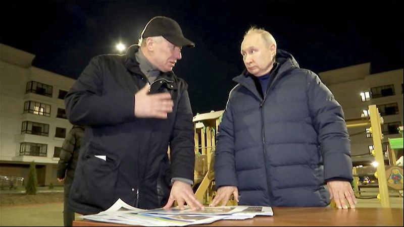 &copy; Reuters. Russian President Vladimir Putin listens to Deputy Prime Minister Marat Khusnullin, who heads construction and regional development, as he visits Mariupol, Russian-controlled Ukraine, in this still image taken from handout video released on March 19, 2023