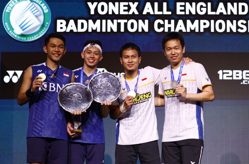 &copy; Reuters. Badminton - All England Open Badminton Championships - Utilita Arena, Birmingham, Britain - March 19, 2023 Indonesia's Fajar Alfian and Muhammad Rian Ardianto celebrate on the podium after winning the men's doubles final along with runners-up Indonesia's 