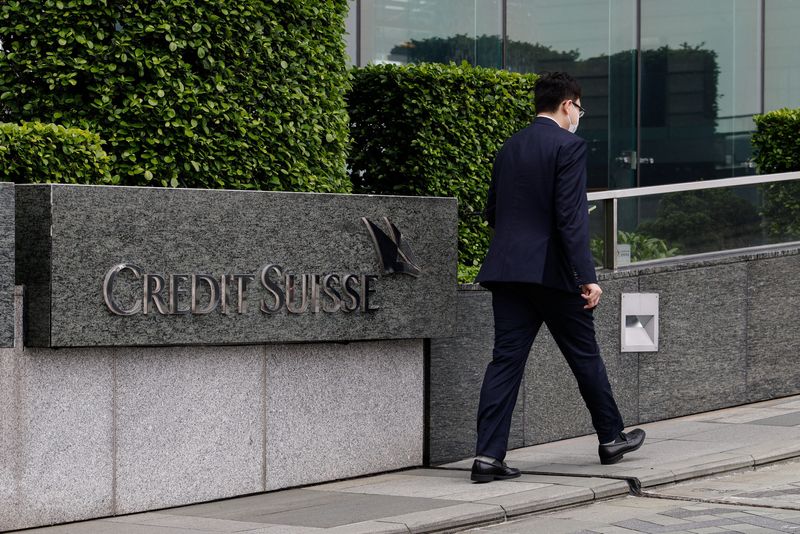 &copy; Reuters. A person walks past the logo of Credit Suisse outside its office building in Hong Kong, China March 20, 2023. REUTERS/Tyrone Siu