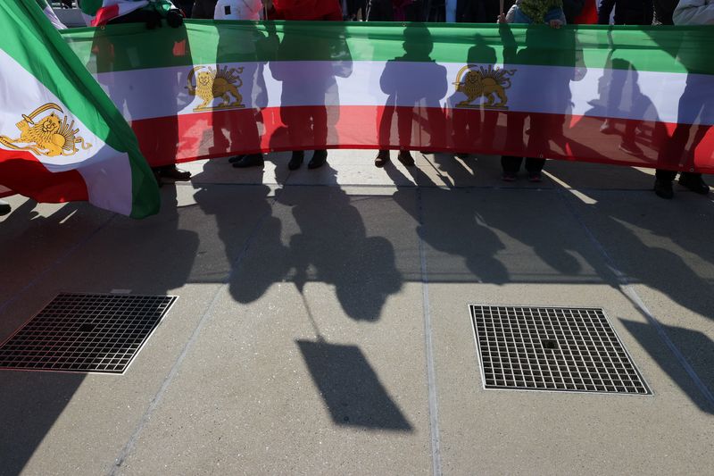 &copy; Reuters. People hold flags during a demonstration against the Republic of Iran in the Place des Nations during the Human Rights Council at the United Nations in Geneva, Switzerland, February 27, 2023. REUTERS/Denis Balibouse/File Photo