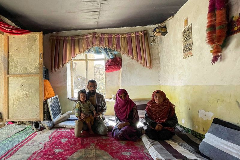 &copy; Reuters. The family of Khair Mohammad, who has lost his legs due to mine explosion, poses for a photograph in their house in Kabul, Afghanistan, March 19, 2023. REUTERS/Sayed Hassib