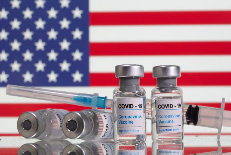 &copy; Reuters. FILE PHOTO: Vials labelled "COVID-19 Coronavirus Vaccine" and sryinge are seen in front of displayed USA flag in this illustration taken, February 9, 2021. REUTERS/Dado Ruvic/Illustration