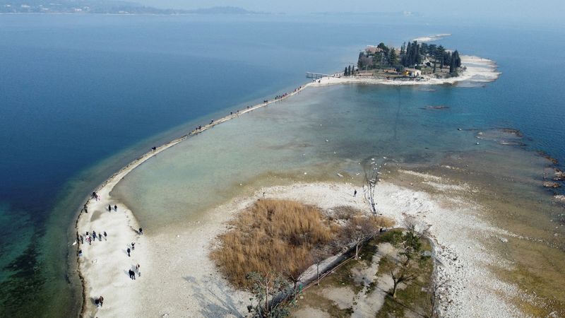 &copy; Reuters. FILE PHOTO: A drone image shows San Biagio island, affected by drought in Lake Garda, near Lido di Manerba, Italy, February 21, 2023. REUTERS/Alex Fraser