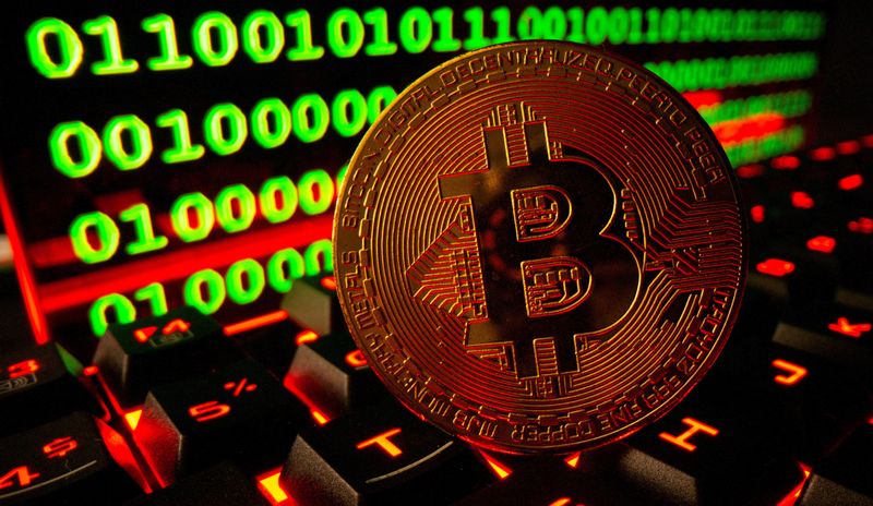 © Reuters. FILE PHOTO: Bitcoin cryptocurrency representation is pictured on a keyboard in front of binary code in this illustration taken September 24, 2021. REUTERS/Dado Ruvic/Illustration/File Photo