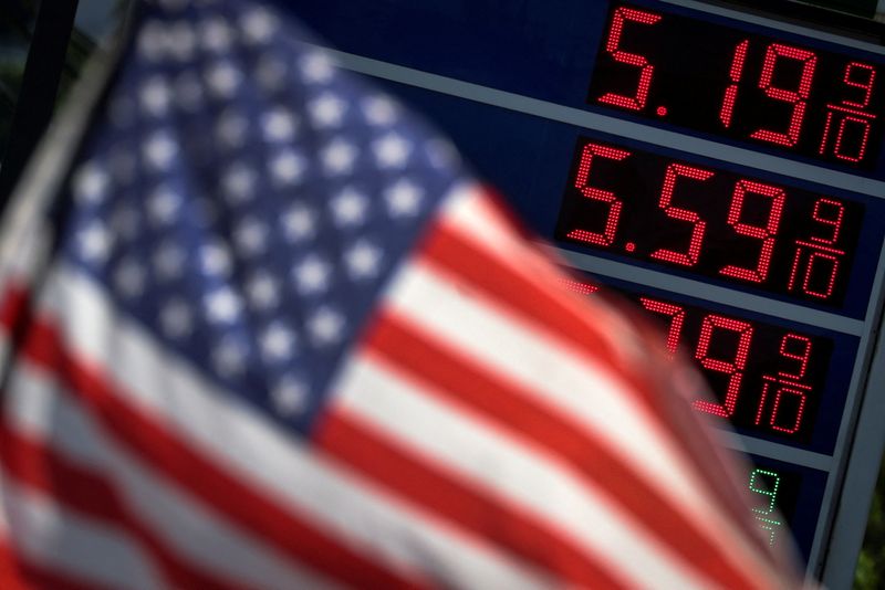 &copy; Reuters. FILE PHOTO: Gasoline prices are displayed at an Exxon gas station behind American flag in Edgewater, New Jersey, U.S., June 14, 2022. REUTERS/Mike Segar/File Photo