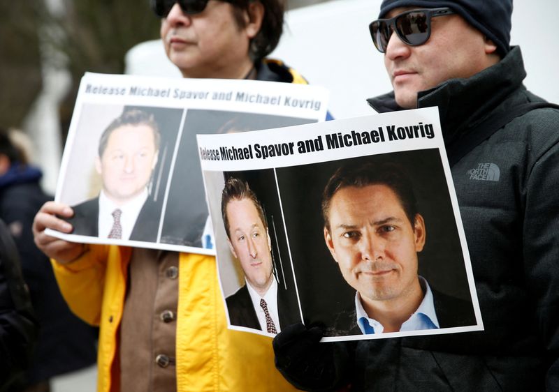 &copy; Reuters. FILE PHOTO: People hold signs calling for China to release Canadian detainees Michael Spavor and Michael Kovrig during an extradition hearing for Huawei Technologies Chief Financial Officer Meng Wanzhou at the B.C. Supreme Court in Vancouver, British Colu