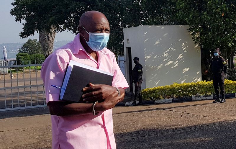 &copy; Reuters. FILE PHOTO: Paul Rusesabagina, portrayed as a hero in a Hollywood movie about Rwanda's 1994 genocide, walks in handcuffs to a courtroom in Kigali, Rwanda February 26, 2021. REUTERS/Clement Uwiringiyimana/File Photo