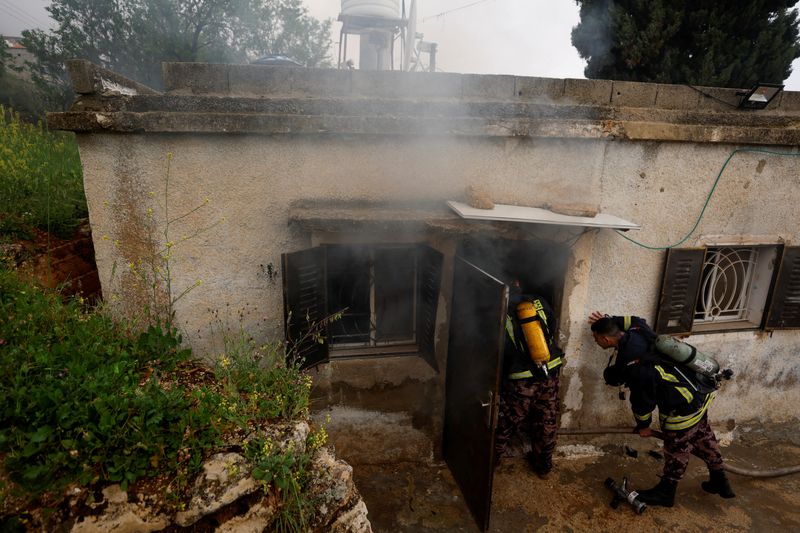 &copy; Reuters. Firefighters work at a Palestinian house which Palestinians say was attacked by Israeli settlers near Ramallah in the Israeli-occupied West Bank, March 26, 2023. REUTERS/Mohammed Torokman