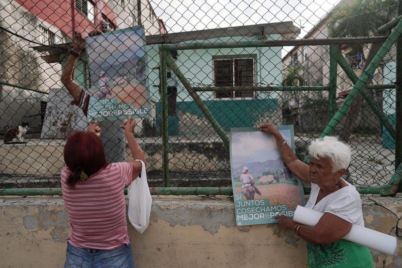 &copy; Reuters. Pessoas penduram cartazes anunciando as próximas eleições legislativas em Havana, Cuba
25/03/2023
REUTERS/Alexandre Meneghini