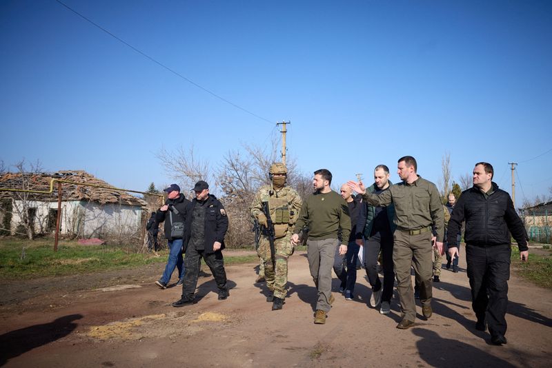 &copy; Reuters. FILE PHOTO: Ukraine's President Volodymyr Zelenskiy walks along a street in a village, amid Russia's attack on Ukraine, as he visits Kherson region, Ukraine March 23, 2023. Ukrainian Presidential Press Service/Handout via REUTERS 