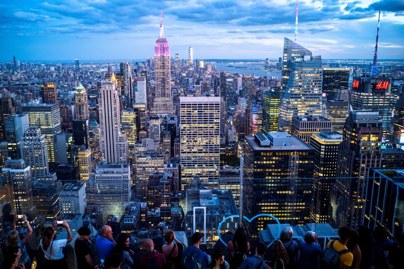 © Reuters. FILE PHOTO: People enjoy the Manhattan skyline during sunset, from the Top of the Rock observation deck, at Rockefeller Center, in New York, U.S., June 28, 2022. REUTERS/Athit Perawongmetha