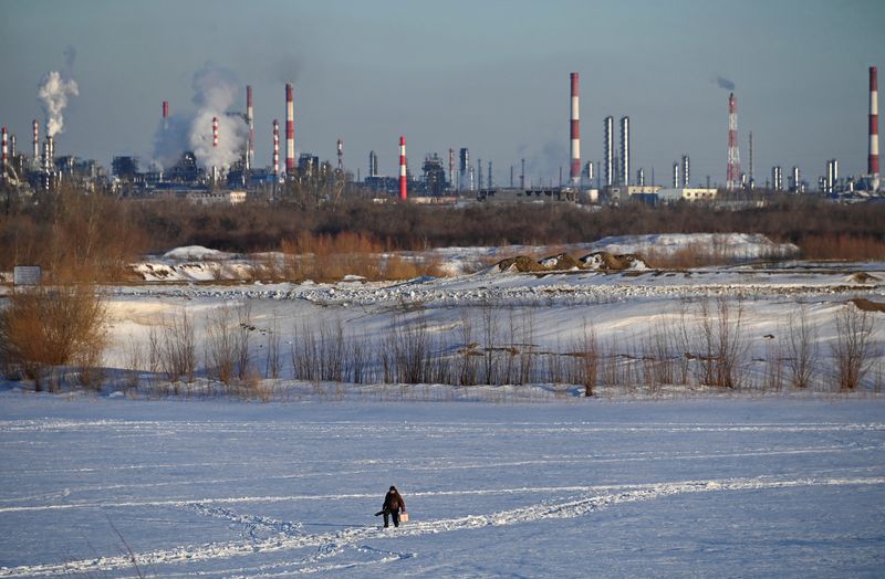 &copy; Reuters. Un homme marche près d'une raffinerie de pétrole à Omsk, en Russie. /Photo prise le 12 mars 2023/REUTERS/Alexey Malgavko