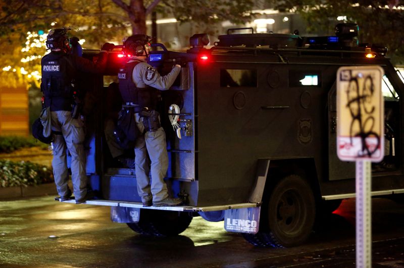 &copy; Reuters. FILE PHOTO: Police officers stand on the back of a vehicle as a response to a protest march that took place on Election Day in Seattle, Washington, U.S. November 3, 2020.  REUTERS/Lindsey Wasson