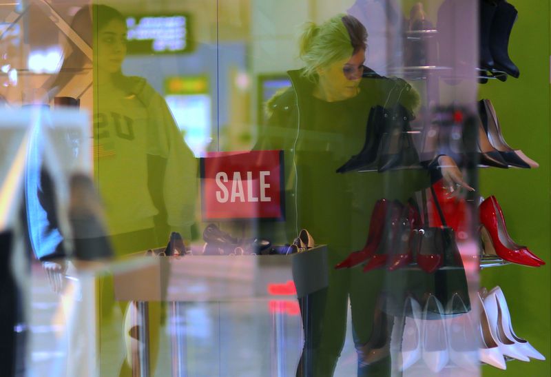 &copy; Reuters. FILE PHOTO: Shoppers can be seen reflected in the window of a retail store selling shoes at a shopping mall in Sydney, Australia, July 25, 2017. Picture taken July 25, 2017.      REUTERS/Steven Saphore