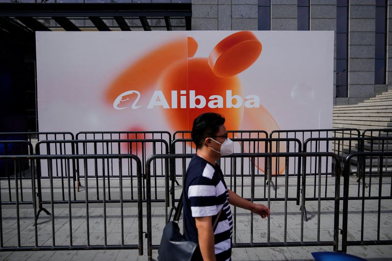 &copy; Reuters. FILE PHOTO: A person walks past a sign of Alibaba Group during the World Artificial Intelligence Conference, following the coronavirus disease (COVID-19) outbreak, in Shanghai, China, September 1, 2022. REUTERS/Aly Song