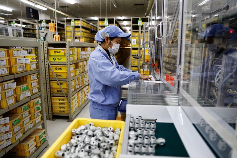 &copy; Reuters. FILE PHOTO: An employee works on a production line manufacturing mechanic parts, amid the coronavirus disease (COVID-19) outbreak, at a factory of SMC Corporation, during an organised media tour, in Beijing, China January 10, 2023. REUTERS/Tingshu Wang