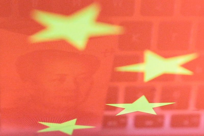 &copy; Reuters. FILE PHOTO: A China yuan banknote featuring late Chinese chairman Mao Zedong and a computer keyboard are seen reflected on an image of Chinese flag in this illustration picture taken November 1, 2019.  REUTERS/Florence Lo/Illustration