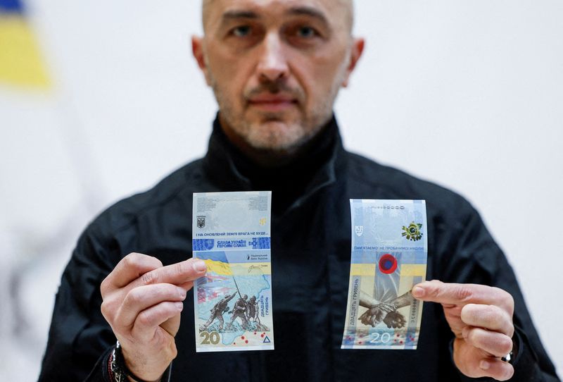 &copy; Reuters. FILE PHOTO: Governor of the National Bank of Ukraine Andriy Pyshnyi holds banknotes dedicated to the first anniversary of Russia's invasion on Ukraine, during a presentation in Kyiv, Ukraine February 23, 2023. REUTERS/Valentyn Ogirenko