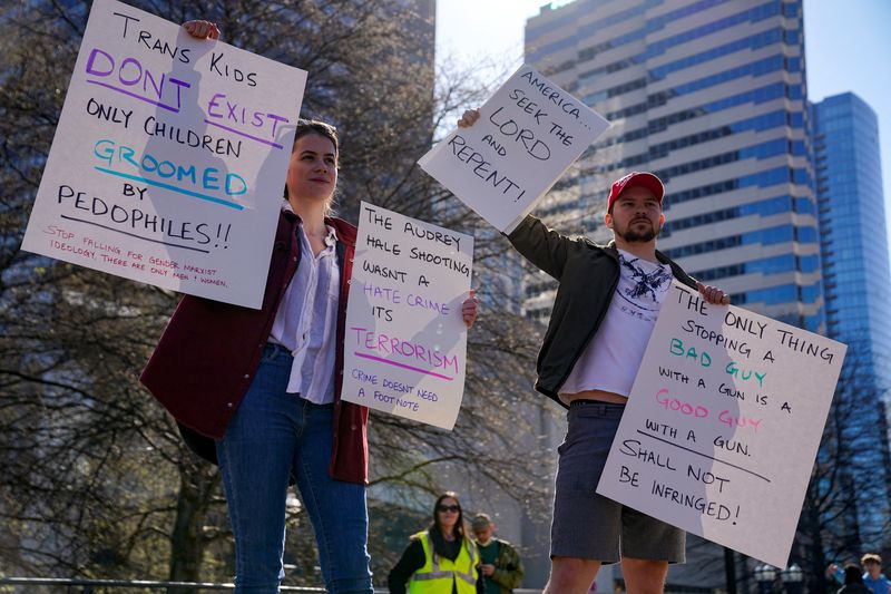&copy; Reuters. Counter protesters hold anti-trans signs outside the Tennessee State Capitol to call for an end to gun violence and support stronger gun laws after a deadly shooting at the Covenant School in Nashville, Tennessee, U.S. March 30, 2023. REUTERS/Cheney Orr