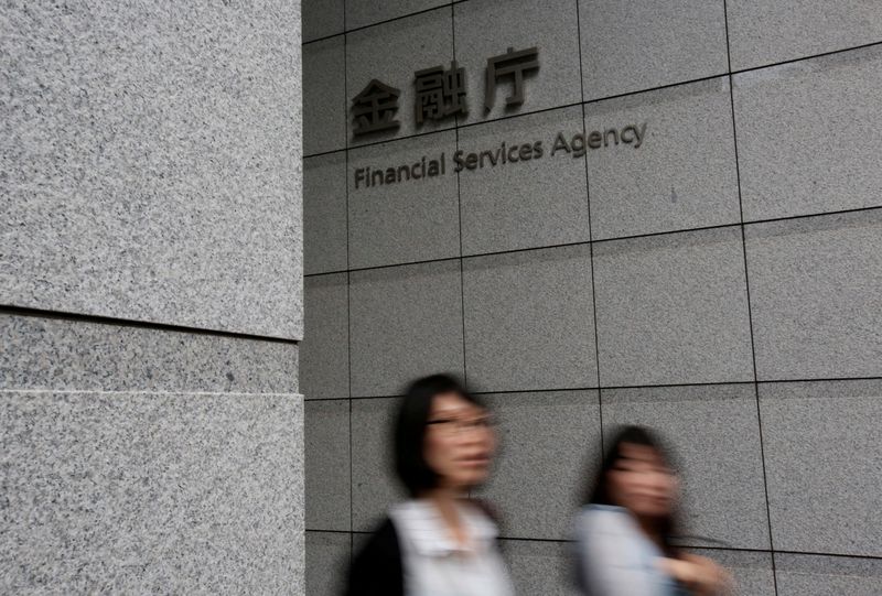 &copy; Reuters. FILE PHOTO: Women walk under a sign of Japan's Financial Services Agency in Tokyo, Japan June 29, 2017. Picture taken June 29, 2017.  REUTERS/Issei Kato