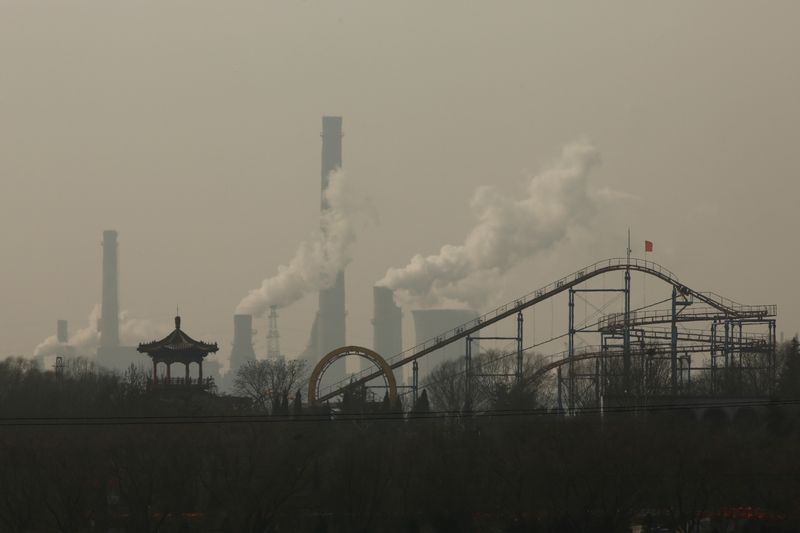 &copy; Reuters. FILE PHOTO: Cooling towers emit steam and chimneys billow in an industrial zone in Wu'an, Hebei province, China, February 23, 2017. REUTERS/Thomas Peter
