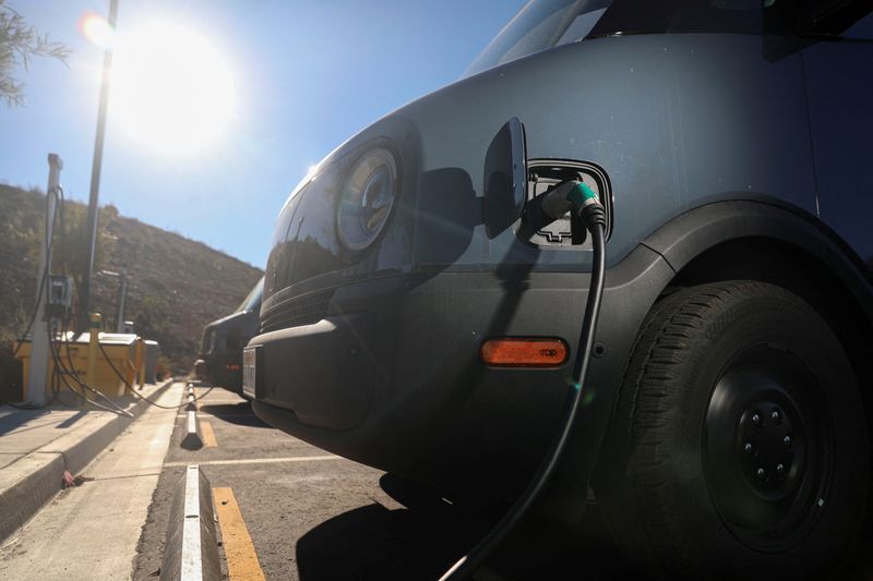 &copy; Reuters. FILE PHOTO: Electric Rivian trucks purchased by Amazon are pictured charging at the Amazon facility in Poway, California, U.S., November 16, 2022.  REUTERS/Sandy Huffaker