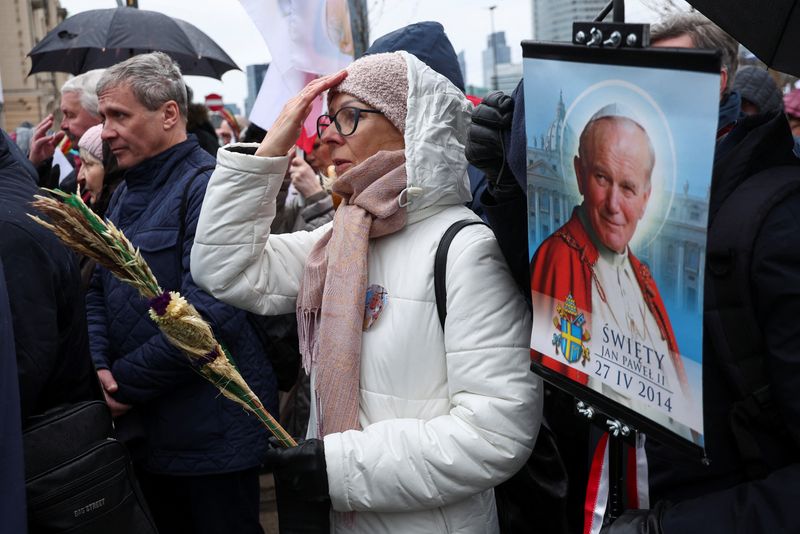 &copy; Reuters. A woman prays as she participates in a march, in defense of pope John Paul II on his death anniversary in Warsaw, Poland, April 2, 2023. REUTERS/Kacper Pempel