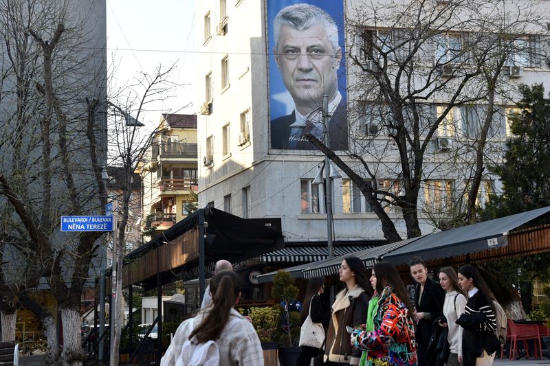 &copy; Reuters. FILE PHOTO: People walk near a banner displaying former Kosovo President Hashim Thaci, in Pristina, Kosovo, March 30, 2023. REUTERS/Laura Hasani