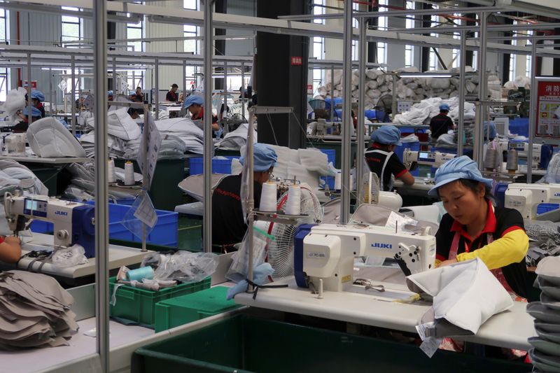 &copy; Reuters. FILE PHOTO: Employees work on the production line of American infant product and toy manufacturer Kids II Inc. at a factory in Jiujiang, Jiangxi province, China June 22, 2021. REUTERS/Gabriel Crossley