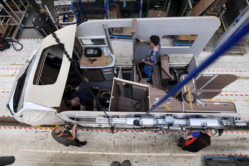 &copy; Reuters. FILE PHOTO: Workers assemble a camper at the Knaus-Tabbert AG factory in Jandelsbrunn near Passau, Germany, March 16, 2021.  REUTERS/Andreas Gebert/File Photo 