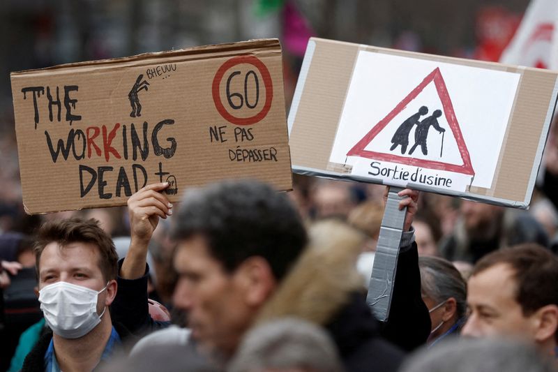 &copy; Reuters. FILE PHOTO: Demonstrators hold signs at a march against the government's pension reform plan in Paris, France, March 11, 2023. REUTERS/Benoit Tessier/File Photo